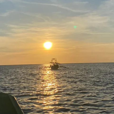 A boat silhouetted against the Boracay sunset