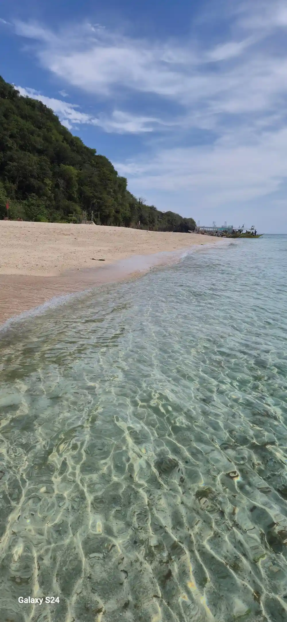 ripples running over a long empty stretch of pale sand